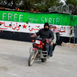 FILE PHOTO: Men ride a bike outside Sednaya prison, after rebels seized the capital and announced that they have ousted President Bashar al-Assad, in Sednaya, Syria December 11, 2024. REUTERS/Ammar Awad/File Photo