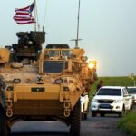 (FILES) In this file photo taken on April 28, 2017 US forces, accompanied by Kurdish People's Protection Units (YPG) fighters, drive their armoured vehicles near the northern Syrian village of Darbasiyah, on the border with Turkey. - The United States is preparing to withdraw its troops from Syria, US media reported on December 19, 2018, a major move that throws into question America's role in the region. (Photo by DELIL SOULEIMAN / AFP)